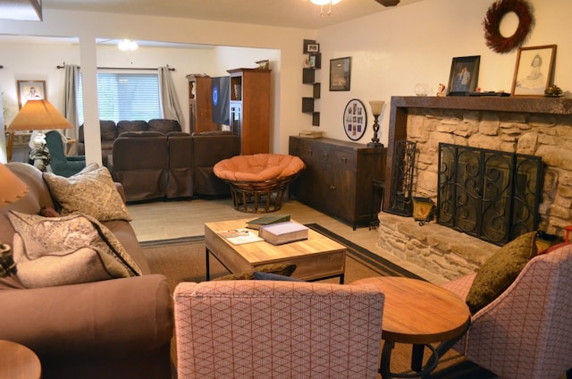 907 Pepperell Ct, Austin, TX 78753 - living room featuring ceiling fan, a stone fireplace, and wood finished floors