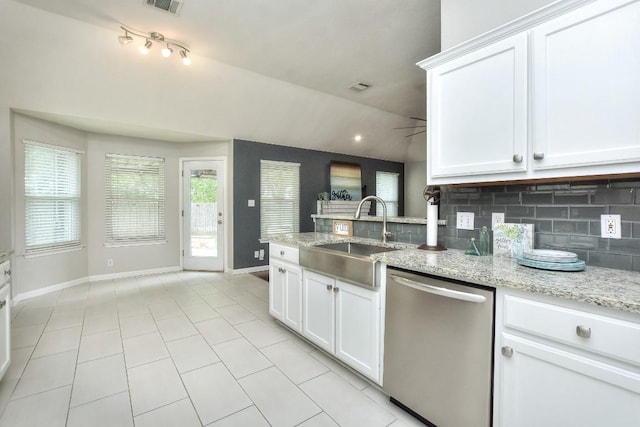 kitchen featuring stainless steel dishwasher, a sink, baseboards, decorative backsplash, and white cabinets