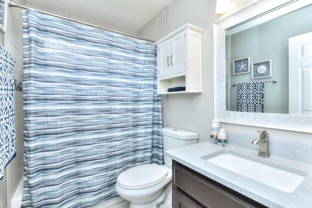 bathroom with vanity, toilet, and a shower with shower curtain