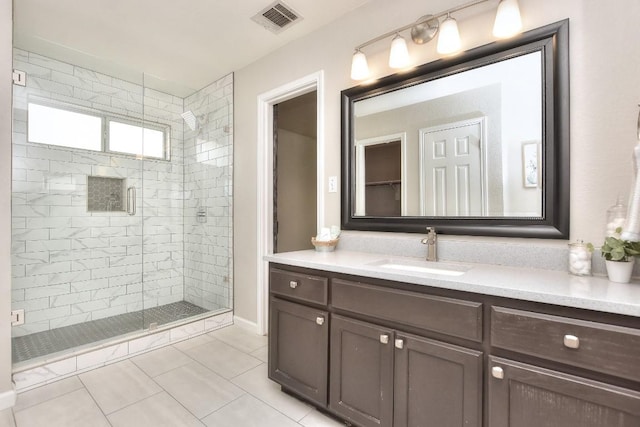 bathroom featuring a stall shower, vanity, and tile patterned floors