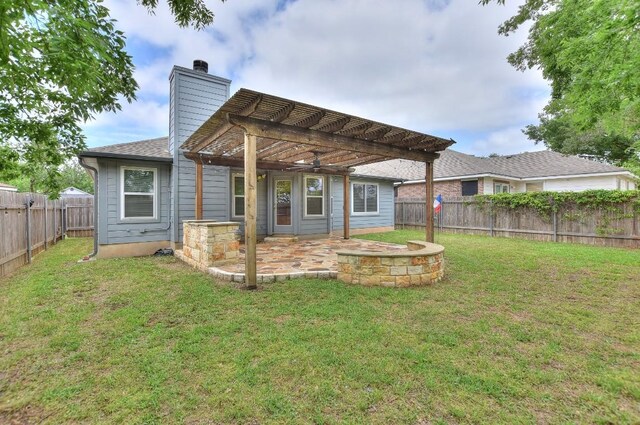 rear view of house with a pergola, a chimney, and a patio area