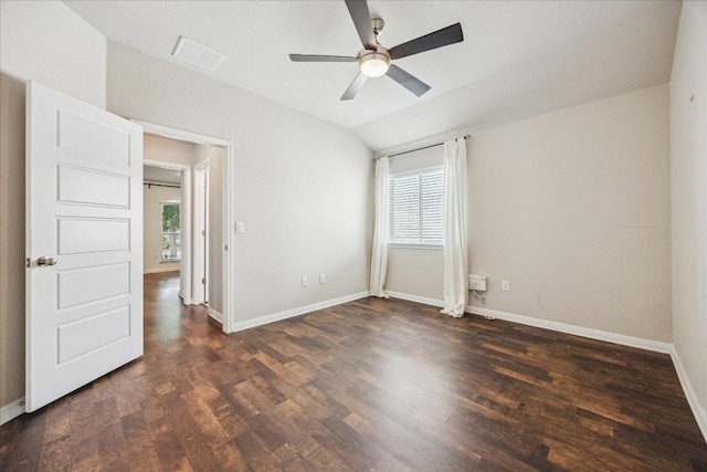 spare room with plenty of natural light, wood finished floors, baseboards, and lofted ceiling