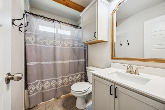 full bathroom featuring toilet, vanity, and tile patterned floors