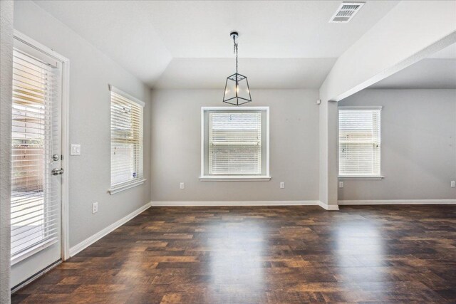 504 Longhorn Cavern Rd, Leander, TX 78641 - unfurnished dining area featuring plenty of natural light, wood finished floors, and vaulted ceiling