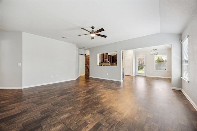 504 Longhorn Cavern Rd, Leander, TX 78641 - unfurnished living room featuring a barn door, dark wood-style flooring, ceiling fan, and lofted ceiling