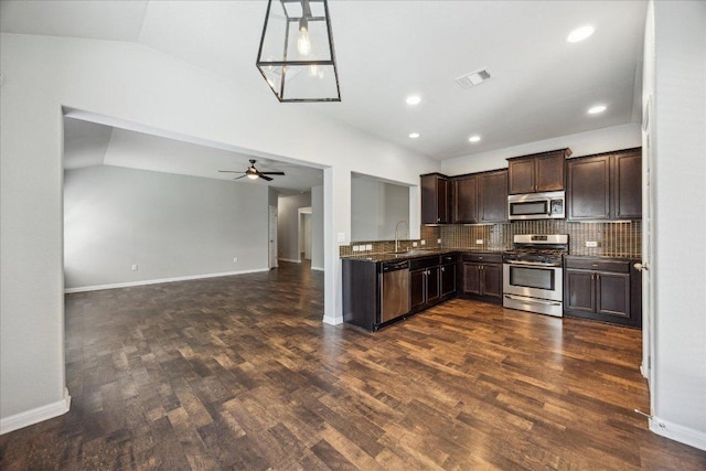 504 Longhorn Cavern Rd, Leander, TX 78641 - kitchen featuring appliances with stainless steel finishes, dark brown cabinets, dark wood finished floors, backsplash, and open floor plan