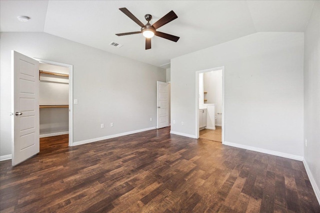 504 Longhorn Cavern Rd, Leander, TX 78641 - unfurnished bedroom with vaulted ceiling, wood finished floors, a walk in closet, a closet, and connected bathroom