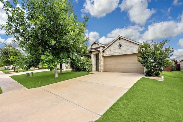 view of front of home featuring stone siding, driveway, a garage, and a front yard