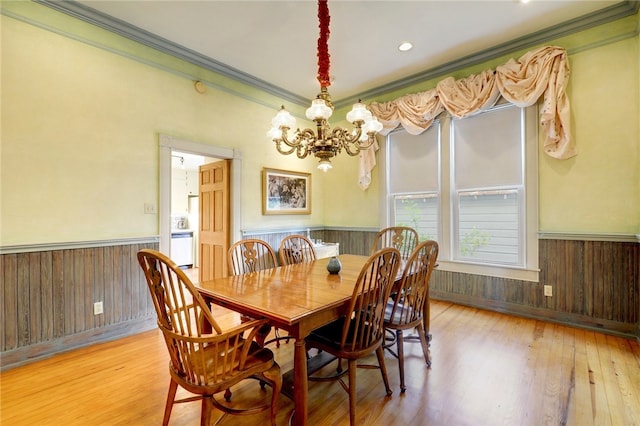101 Short St, Smithville, TX 78957 - dining area featuring wainscoting, a chandelier, crown molding, wood finished floors, and wood walls