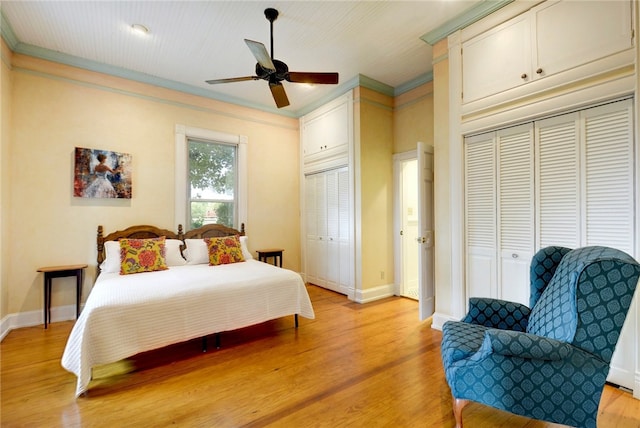 101 Short St, Smithville, TX 78957 - bedroom featuring crown molding, light wood-style flooring, two closets, and a ceiling fan
