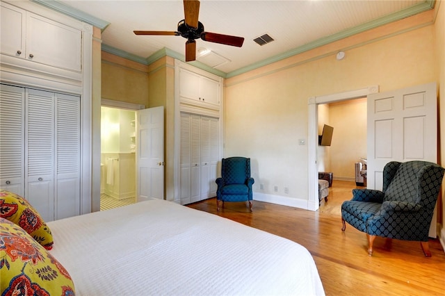 101 Short St, Smithville, TX 78957 - bedroom with multiple closets, crown molding, wood finished floors, and ceiling fan