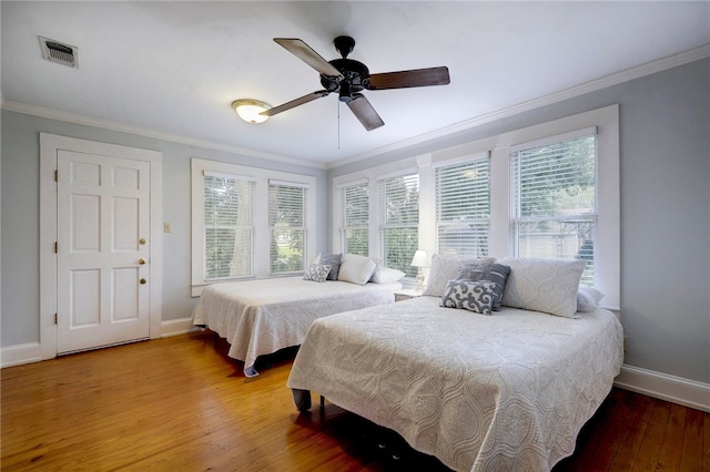 101 Short St, Smithville, TX 78957 - bedroom featuring ornamental molding, hardwood / wood-style flooring, and a ceiling fan