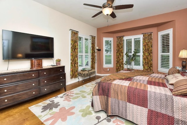 109 Cattle Trail Way, Georgetown, TX 78633 - bedroom with wood finished floors, access to outside, a ceiling fan, and baseboards
