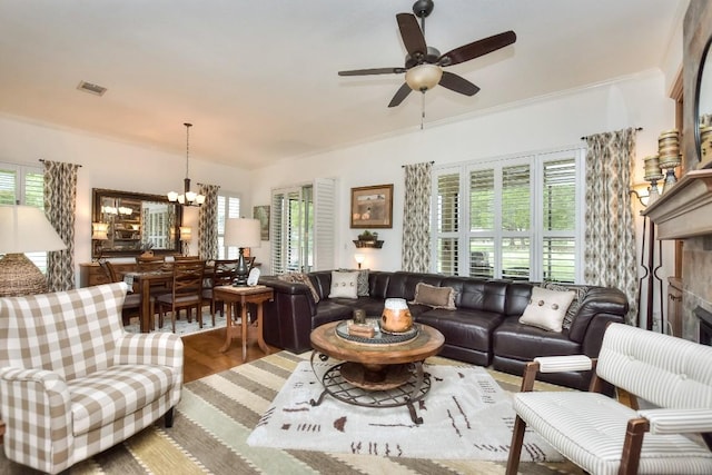 109 Cattle Trail Way, Georgetown, TX 78633 - living area with plenty of natural light, a chandelier, a ceiling fan, wood finished floors, and crown molding