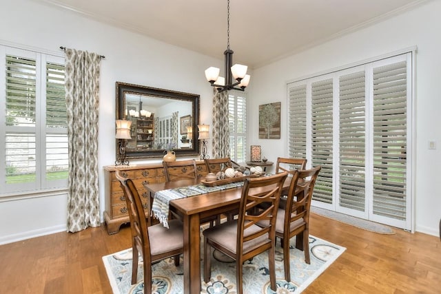 109 Cattle Trail Way, Georgetown, TX 78633 - dining room with a chandelier, ornamental molding, wood finished floors, and baseboards