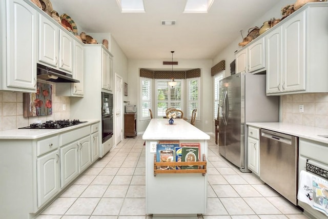 109 Cattle Trail Way, Georgetown, TX 78633 - kitchen featuring black appliances, under cabinet range hood, a center island, and light countertops