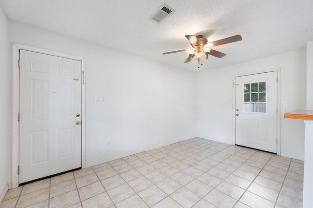 8309 Burrell Dr, Austin, TX 78757 - entrance foyer featuring a ceiling fan, a textured ceiling, and baseboards