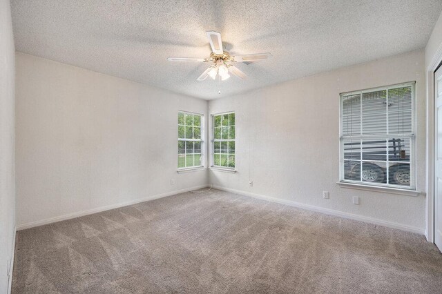 8309 Burrell Dr, Austin, TX 78757 - carpeted spare room with a textured ceiling, ceiling fan, and baseboards