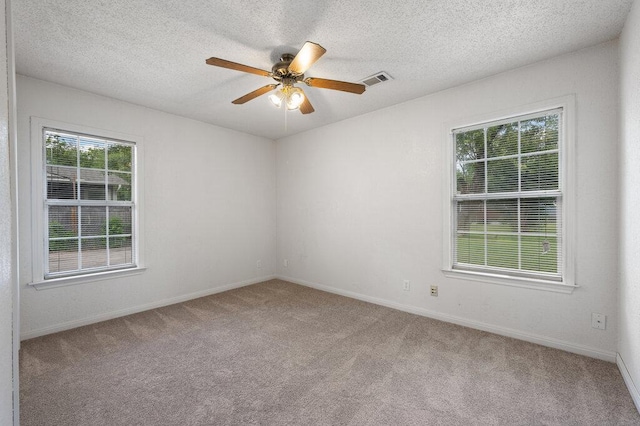 8309 Burrell Dr, Austin, TX 78757 - spare room with carpet floors, a ceiling fan, baseboards, and a textured ceiling