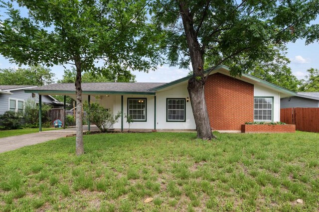 8309 Burrell Dr, Austin, TX 78757 - ranch-style home with concrete driveway, a carport, and brick siding