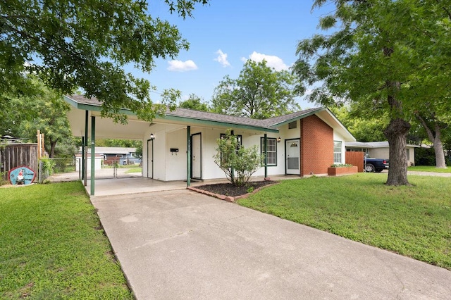 8309 Burrell Dr, Austin, TX 78757 - ranch-style house with concrete driveway, a carport, and a gate