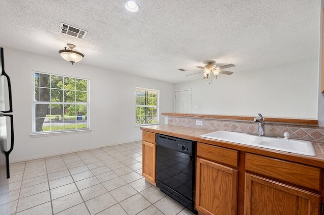 8309 Burrell Dr, Austin, TX 78757 - kitchen featuring black dishwasher, a sink, ceiling fan, brown cabinets, and a textured ceiling