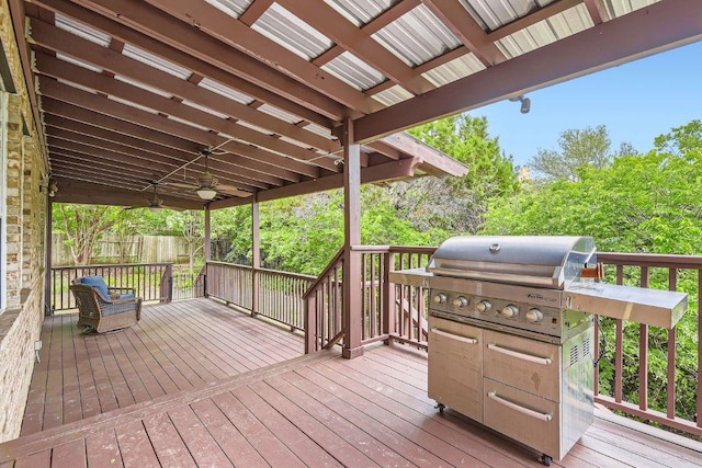 deck featuring grilling area and fence