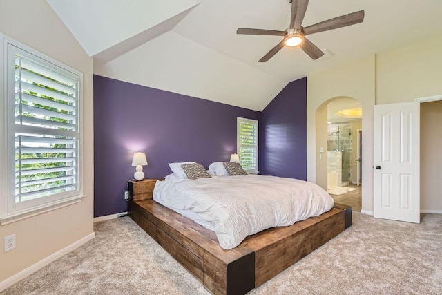 bedroom featuring arched walkways, carpet floors, lofted ceiling, and baseboards