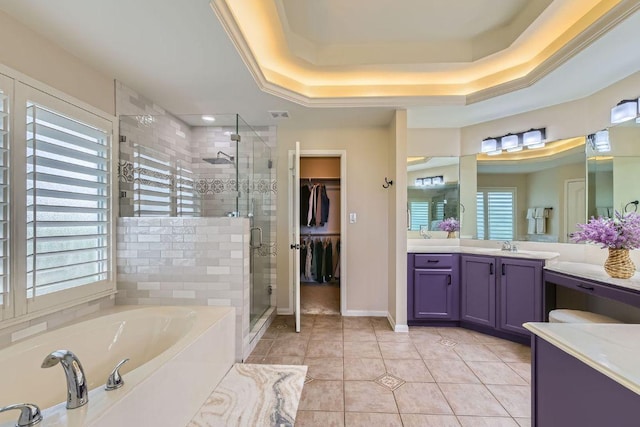 bathroom featuring a stall shower, a garden tub, vanity, tile patterned flooring, and a tray ceiling