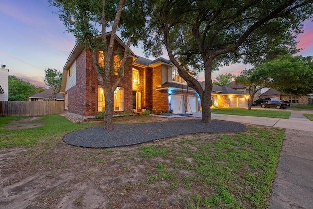 view of front of house featuring concrete driveway and brick siding