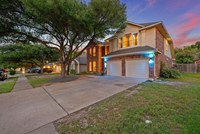 traditional-style house with brick siding, a garage, and concrete driveway
