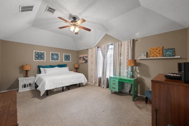 bedroom featuring carpet, vaulted ceiling, a textured ceiling, and ceiling fan