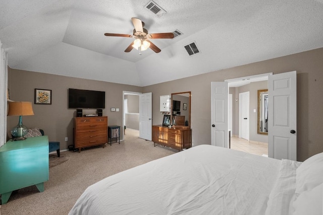bedroom featuring light colored carpet, a ceiling fan, baseboards, and a textured ceiling