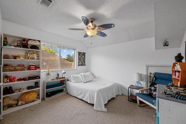 carpeted bedroom featuring a textured ceiling, ceiling fan, and vaulted ceiling