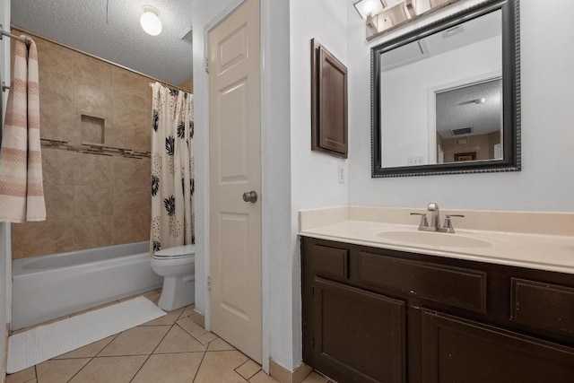 bathroom featuring tile patterned flooring, a textured ceiling, toilet, vanity, and shower / bath combo with shower curtain