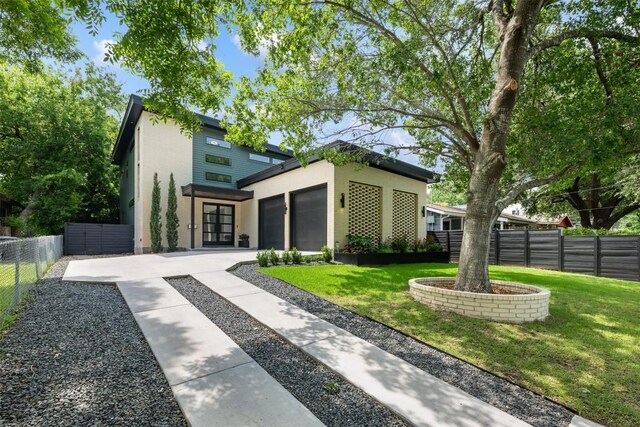 2603 Euclid Ave, Austin, TX 78704 - view of front of property featuring an attached garage, stucco siding, concrete driveway, and french doors
