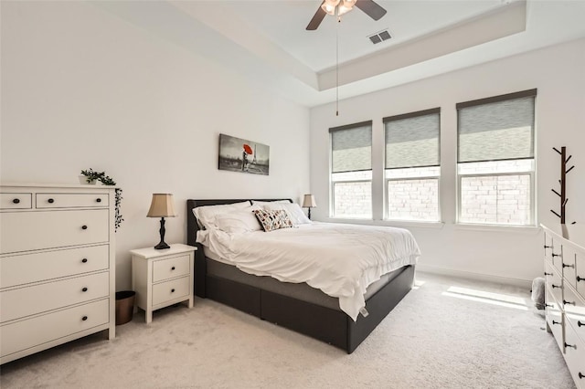 4608 Modena Bay Bnd, Leander, TX 78641 - bedroom with light colored carpet, a tray ceiling, and ceiling fan