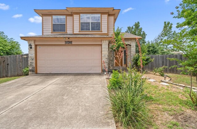 13306 James Monroe St, Manor, TX 78653 - traditional-style home featuring stone siding, driveway, and an attached garage