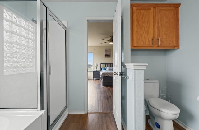 13306 James Monroe St, Manor, TX 78653 - bathroom with a stall shower, a ceiling fan, ensuite bath, wood finished floors, and toilet