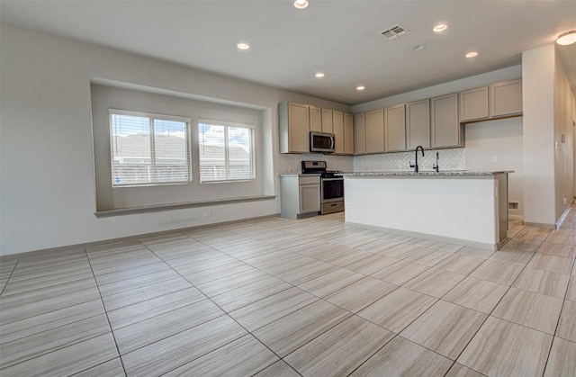 286 Spinnaker Loop, Kyle, TX 78640 - kitchen with stainless steel appliances, decorative backsplash, light countertops, recessed lighting, and a center island with sink