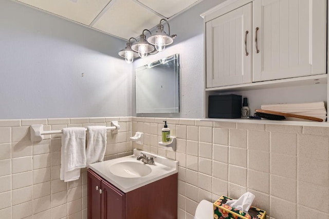 1800 Lavaca St Unit A-514, Austin, TX 78701 - bathroom featuring vanity, a wainscoted wall, and tile walls