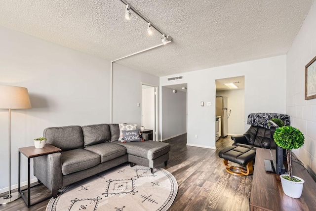 1800 Lavaca St Unit A-514, Austin, TX 78701 - living room featuring wood finished floors, a textured ceiling, track lighting, and baseboards