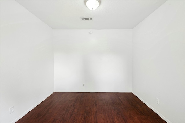 unfurnished room with wood finished floors and baseboards