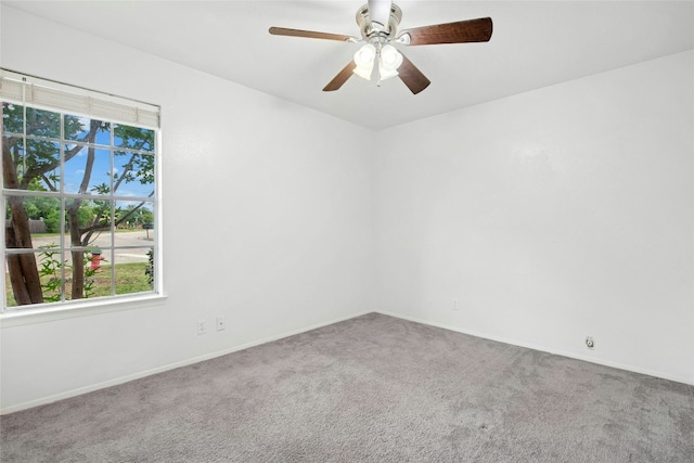 unfurnished room featuring carpet floors, baseboards, and a ceiling fan
