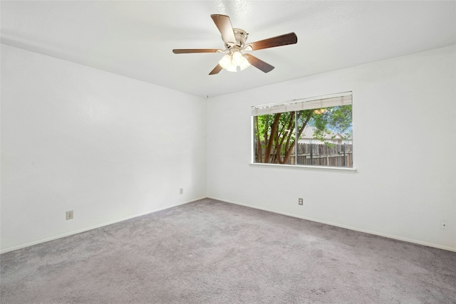 empty room featuring carpet flooring, a ceiling fan, and baseboards