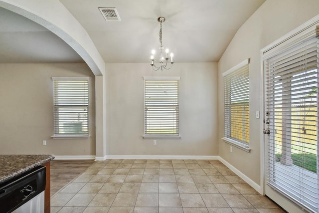 352 Voyager Cv, Kyle, TX 78640 - unfurnished dining area featuring a chandelier, arched walkways, baseboards, and light tile patterned floors