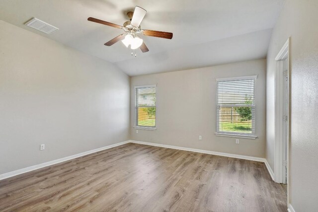 352 Voyager Cv, Kyle, TX 78640 - spare room with wood finished floors, lofted ceiling, a ceiling fan, and baseboards