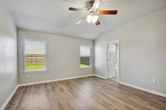 352 Voyager Cv, Kyle, TX 78640 - unfurnished room with wood finished floors, a ceiling fan, lofted ceiling, and baseboards