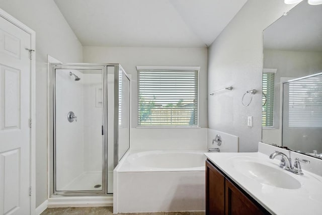 352 Voyager Cv, Kyle, TX 78640 - bathroom with a shower stall, a bath, vanity, and vaulted ceiling