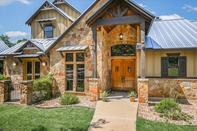 1150 Windmill Run, Wimberley, TX 78676 - property entrance featuring stone siding, a standing seam roof, metal roof, and board and batten siding